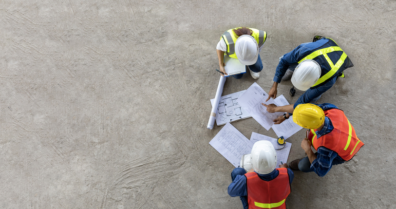 Top view of engineer, architect, contractor and foreman meeting at the construction building site with floor plan for real estate development project industry and housing timeline usage