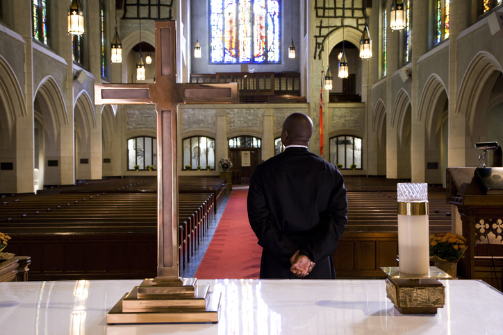 Priest waiting for a sign in church